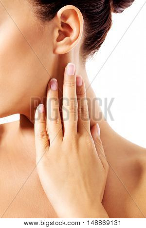 Young woman scratching her neck.