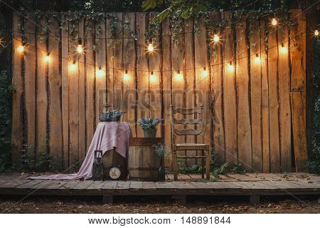 Evening Wooden Stage In The Garden With Lamps For Parties Or Wedding