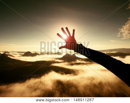 Man Hand Touch Sun. Misty Daybreak In A Beautiful Hills. Hilly Landscape In Fog