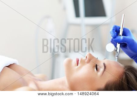 Picture of woman having facial treatment in beauty salon
