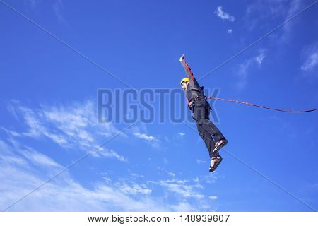 The first jump off the cliff with a safety rope.