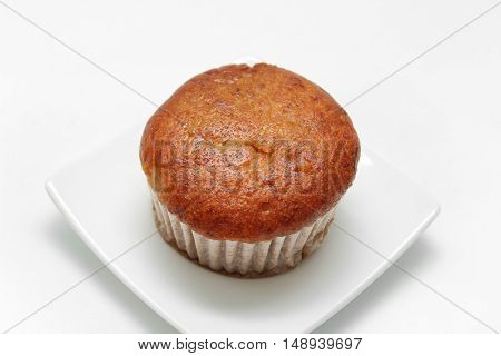 Banana cupcake with chololate on white plate
