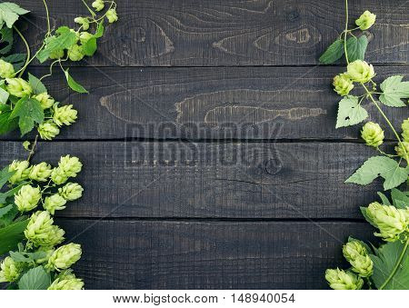 Border From Green Hop Branches On Dark Rustic Wooden Background. Concept Of Beer Production. Mock Up