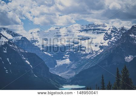 Mountain Peaks With Snow And Cloudy Sky