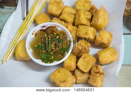Snack and dessert deep fried tofu or fried Bean curd served with sweet and sour spicy sauce.
