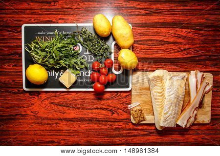 Fresh farmers market fruit and vegetable with fish fillet on red table