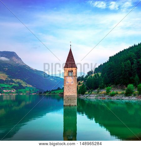 Beautiful view of the lake Resia. Famous tower in the water. Alps, Italy, Europe.