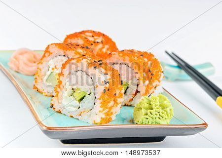 California maki sushi with masago. Roll made of crab meat, avocado, cucumber and orange masago. Shallow depth of field.