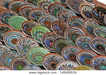 Background with Romanian traditional ceramic in the plates form painted with specific patterns from Horezu area.