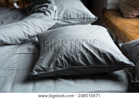 Close-up Of Gray Pillows On The Bed Near Window