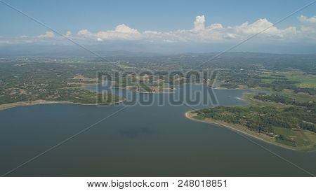 Aerial View Of Paoay Lake Against Background Of Mountains And Sky With Clouds. Paoay Lake National P