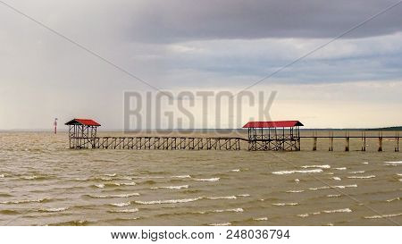 Pier & Hut With Stormy Dark Sunset In Tropical Sea In Sipitang,sabah Borneo,malaysia.