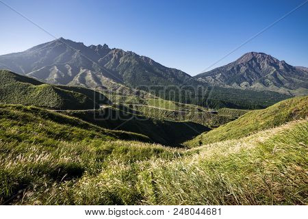 Mount Nekodake And Mount Takadake Of Aso Mountain Range Under Blue Sky In Kumamoto