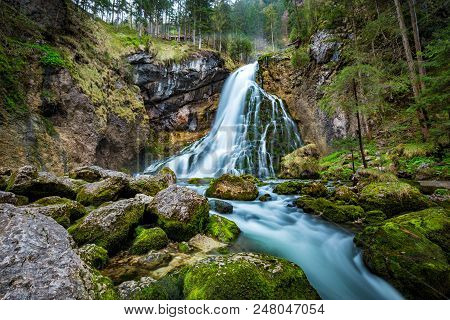 Beautiful View Of Famous Gollinger Wasserfall With Mossy Rocks And Green Trees On A Moody In Springt