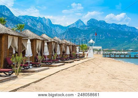 Antalya, Turkey - 10 May 2018: Wooden Beach Pavilions On The Shore Of A Sandy Beach - The Mediterran