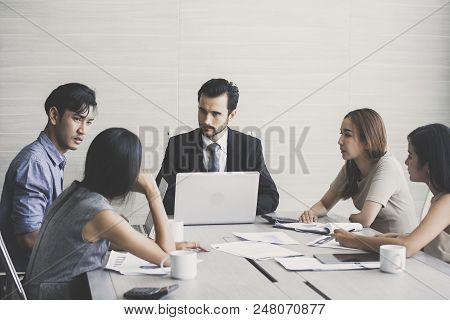 Young Business People Working Together With Serious Emotion. Business People Takling In Modern Offic