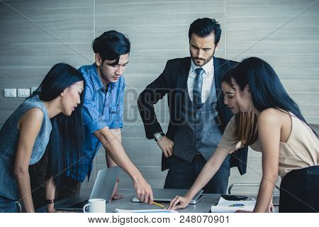 Young Business People Working Together With Serious Emotion. Business People Takling In Modern Offic