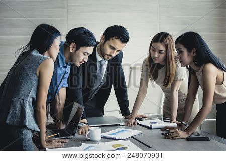 Young Business People Working Together With Serious Emotion. Business People Takling In Modern Offic