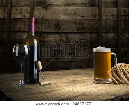 Red Wine Bottle And Wine Glass On Wodden Barrel.