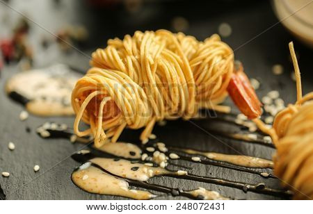 Close Up Food Photo Of Fried Tiger Prawns In Egg Noodles On Black Slate Background. Asian Culture An