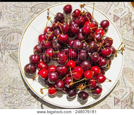 Fresh Ripe Cherry On A Plate, Top View.