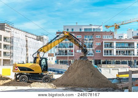 Excavator In Construction Site. Buildingindustry And New Building Concept
