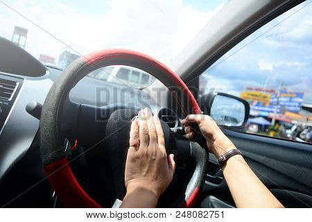 Hand Of Adult Woman  Handle With The Horn Panel At The Steering Wheel In Car While Driving In The Ci