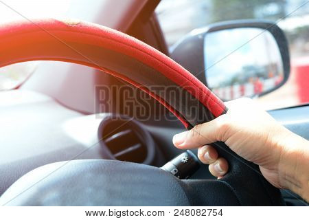 Hand Of Adult Woman  Handle With  The Steering Wheel In Car While Driving In The City