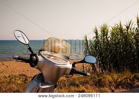 A Generic White Scooter Bike Is Parked At The Seaside Of The Island Of Sal, Cape Verde. The Tropical