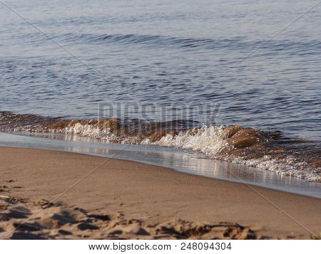 Sandy Shore Of The Lake. Small Waves