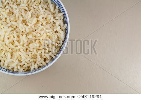 Cooked Brown Rice In A Blue And White Bowl