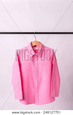 Hanging Pink Shrits On White Background, Hanger.