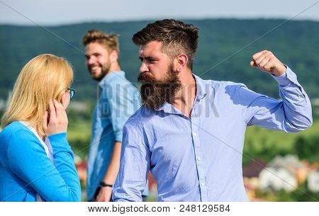 Husband Strictly Watching His Wife Looking At Another Guy While Walk. Violence Concept. Man With Bea