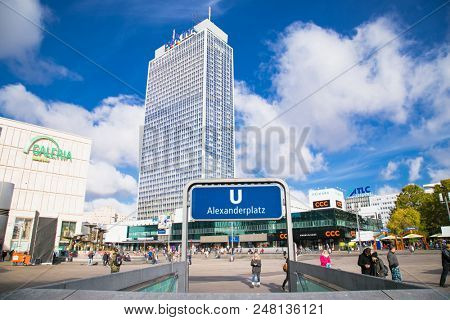 BERLIN GERMANY - OCT 30, 2016: People near fountain on Alexanderplatz square in Berlin city on Oct 30, 2016. Germany. Alexanderplatz is large public square and transport hub in central Mitte district