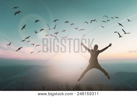 Happy Man Rise Hand On Morning View. Christian Inspire Praise God On Good Friday Background. Now One