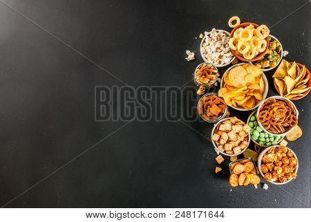Variation Different Unhealthy Snacks Crackers, Sweet Salted Popcorn, Tortillas, Nuts, Straws, Bretse