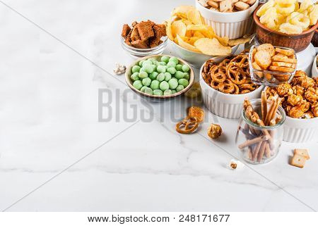 Variation Different Unhealthy Snacks Crackers, Sweet Salted Popcorn, Tortillas, Nuts, Straws, Bretse