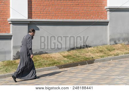 Samara, Russia - June 19, 2018: The Monk Walks Down The Street Along The Monastery Wall