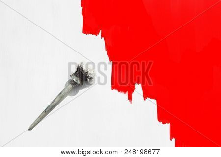 Paint Brush In White Paint On A Wooden Background Is Painted In White And Half In Red. Flat Lay, Top