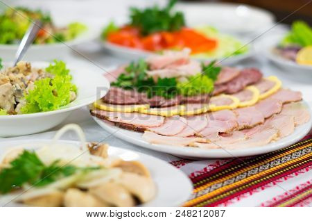 Thinly Sliced Ham Arranged On White Plate.