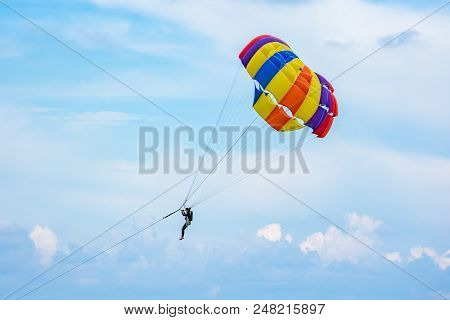 People Playing Parashoot On The Sky Summer Season
