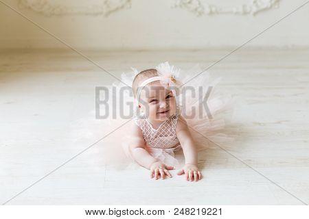 Baby Girl Wearing A Peach Tutu. Cute Girl
