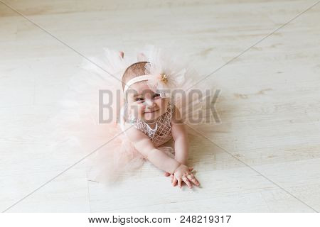 Baby Girl Wearing A Peach Tutu. Cute Girl