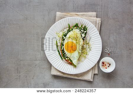 Spring Sandwich On Plate Flat Lay. Green Aspargus, Fried Egg, Feta Cheese And Micro Greens Over Ligh