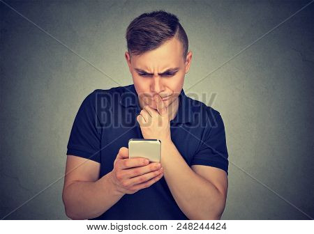 Clueless Dumb Guy Having Troubles With His Smartphone. Complicated Technology Concept
