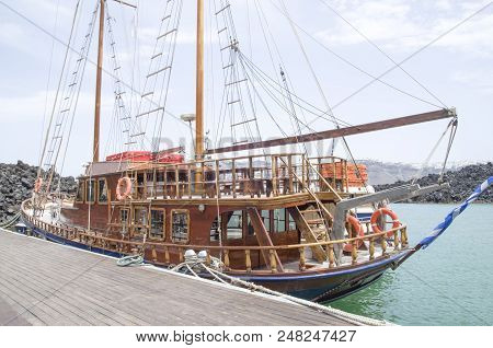 Wooden Ship On Port Of Nea Kameni Volcanic Island Near Santorini, Greece