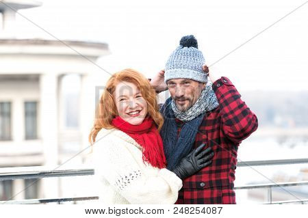 Couple In Red. Guy In Hat And Red Hair Girl. Happy Woman Hugs Men. Guy Dressed Hat And Smiling Woman