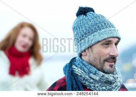 Close Up Men Portrait In Knitted Hat. Happy Guy Portrait With Woman On Background. Closeup Men In Fo