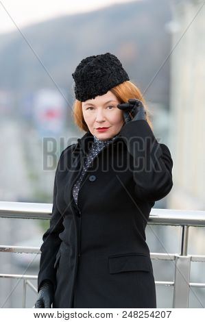 Styled Woman In Black Coat. Rude Lady In Coat, Hat And Gloves. Woman's Serious Look At You. Lady Coq