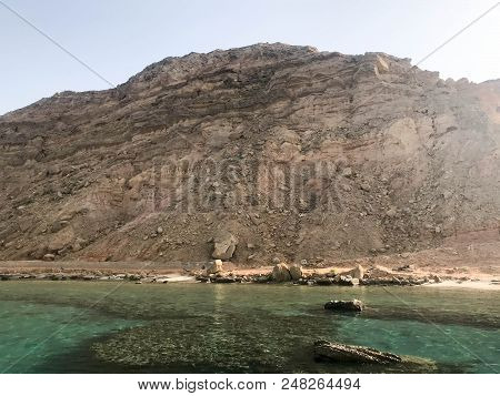 Landscape Of Clear Blue Natural Sea Salt Water, Sea, Ocean With A Bottom Of Coral Reefs, Stones Agai